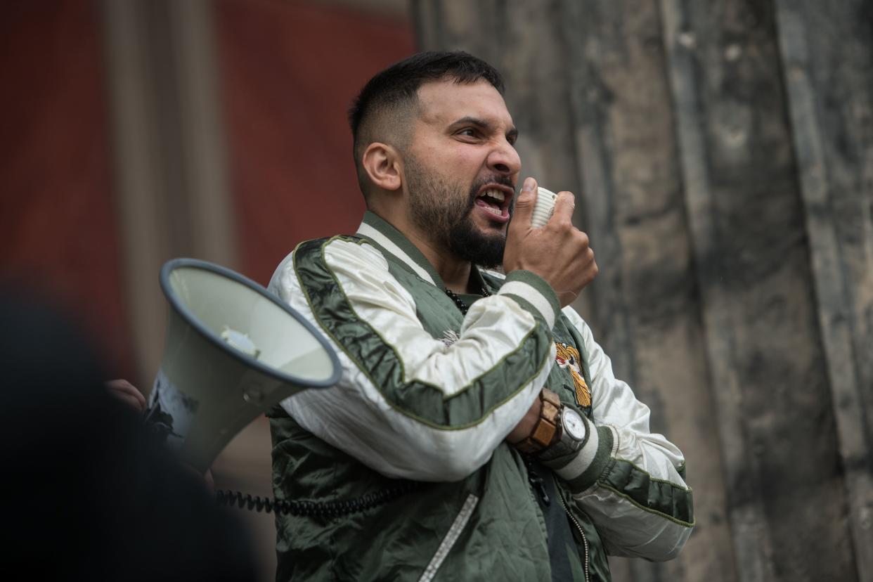 German vegan cookbook author and conspiracy theorist Attila Hildmann speaks during a protest against restrictions implemented in order to limit the spread of the novel coronavirus / COVID-19 pandemic  in front of Altes Museum in Berlin, on June 20, 2020. (Photo by Stefanie LOOS / AFP) (Photo by STEFANIE LOOS/AFP via Getty Images)