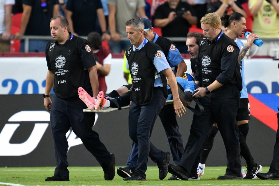 Uruguayan player Maximiliano Araujo is taken off the field on a stretcher after his head collided with defender Tim Ream during a match against the US in Group C of the Copa América, on Monday, July 1, 2024, in Kansas City, Missouri (AP)