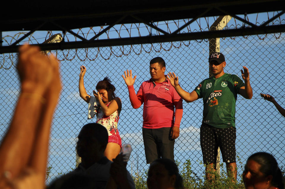 Relatives of inmates pray outside Anisio Jobim Prison Complex after a deadly riot erupted among inmates in Manaus in the northern state of Amazonas, Brazil, Sunday, May 26, 2019. A statement from the state prison secretary says prisoners began fighting among themselves around noon Sunday, and security reinforcements were rushed to complex. (AP Photo/Edmar Barros)