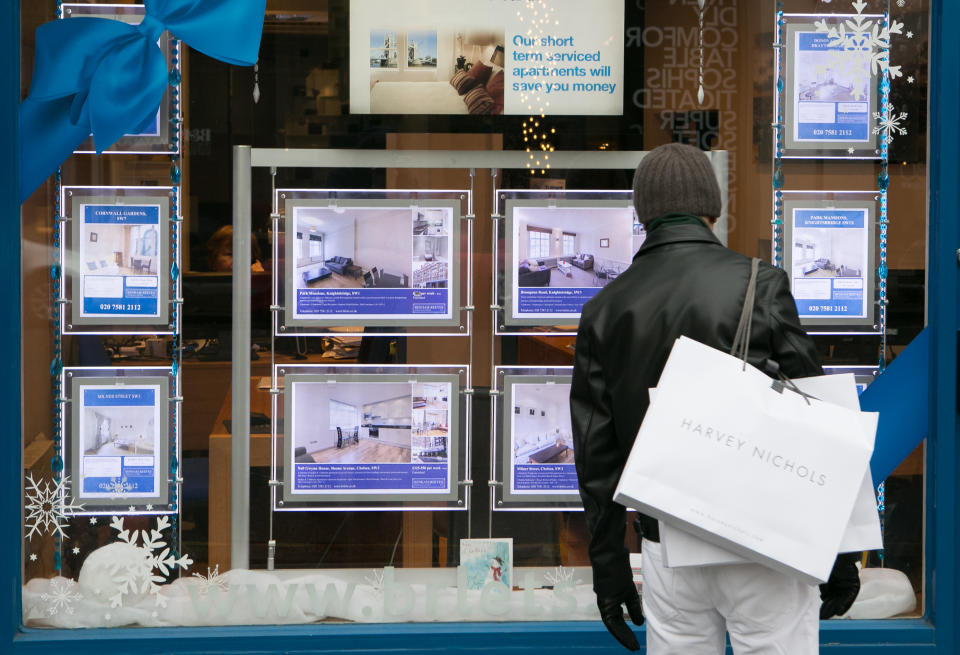 A member of the public looks in the window of an estate agents in South Kensington, London, as the banking chain Halifax has reported that house prices have edged up by 0.4\% month-on-month in November, but there are more signs that the pace of growth is slowing.