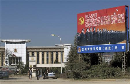 People walk outside a labour camp in Kunming, Yunnan province, November 22, 2013. REUTERS/John Rudwich