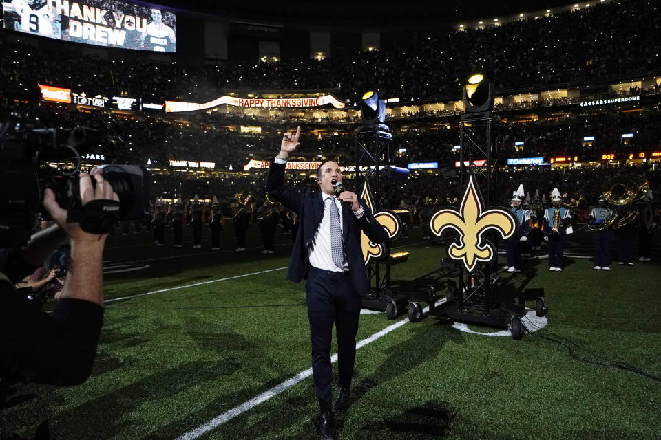 Former New Orleans Saints quarterback Drew Brees leads a crowd cheer as he is honored during a ceremony at halftime of an NFL football game between the New Orleans Saints and the Buffalo Bills in New Orleans, Thursday, Nov. 25, 2021. (AP Photo/Derick Hingle)