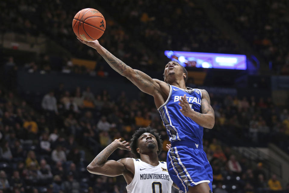 Buffalo guard Armoni Foster, right, is defended by West Virginia guard Kedrian Johnson, left, during the first half of an NCAA college basketball game in Morgantown, W.Va., Sunday, Dec. 18, 2022. (AP Photo/Kathleen Batten)