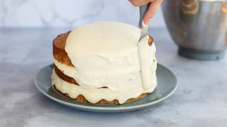 Frosting a carrot cake