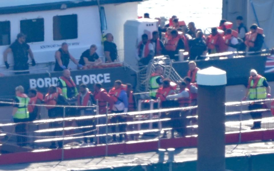 A group of people thought to be migrants being brought in to Dover, Kent, from a Border Force vessel following a small boat incident in the Channel last Friday