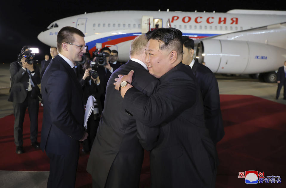 In this photo provided by the North Korean government, Russian President Vladimir Putin, center, and North Korea's leader Kim Jong Un, right, hug during the departure ceremony at an international airport outside Pyongyang, North Korea, Wednesday, June 19, 2024. The content of this image is as provided and cannot be independently verified. Korean language watermark on image as provided by source reads: "KCNA" which is the abbreviation for Korean Central News Agency. (Korean Central News Agency/Korea News Service via AP)