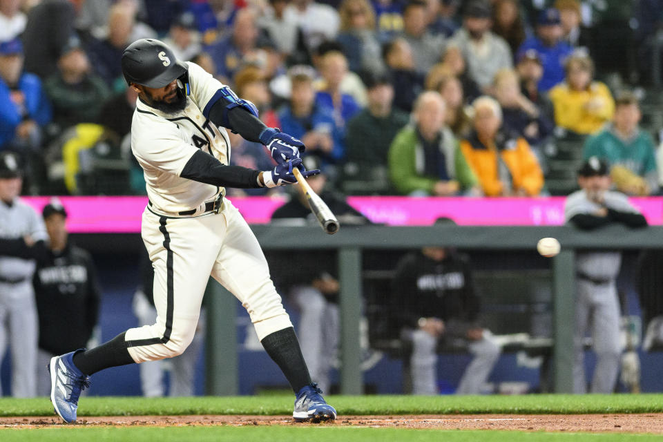 Seattle Mariners designated hitter Teoscar Hernandez hits a single against the Chicago White Sox during the first inning of a baseball game, Saturday, June 17, 2023, in Seattle. (AP Photo/Caean Couto)