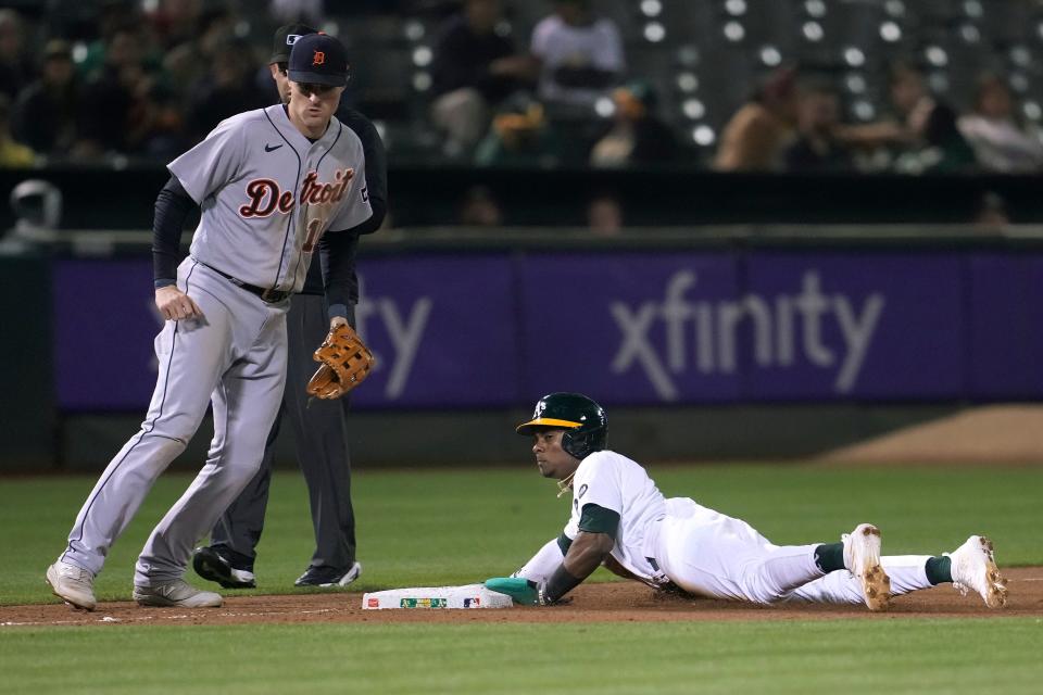 Oakland Athletics' Esteury Ruiz, right, steals third base next to Detroit Tigers third baseman Tyler Nevin during the seventh inning at Oakland Coliseum in Oakland, California, on Friday, Sept. 22, 2023.