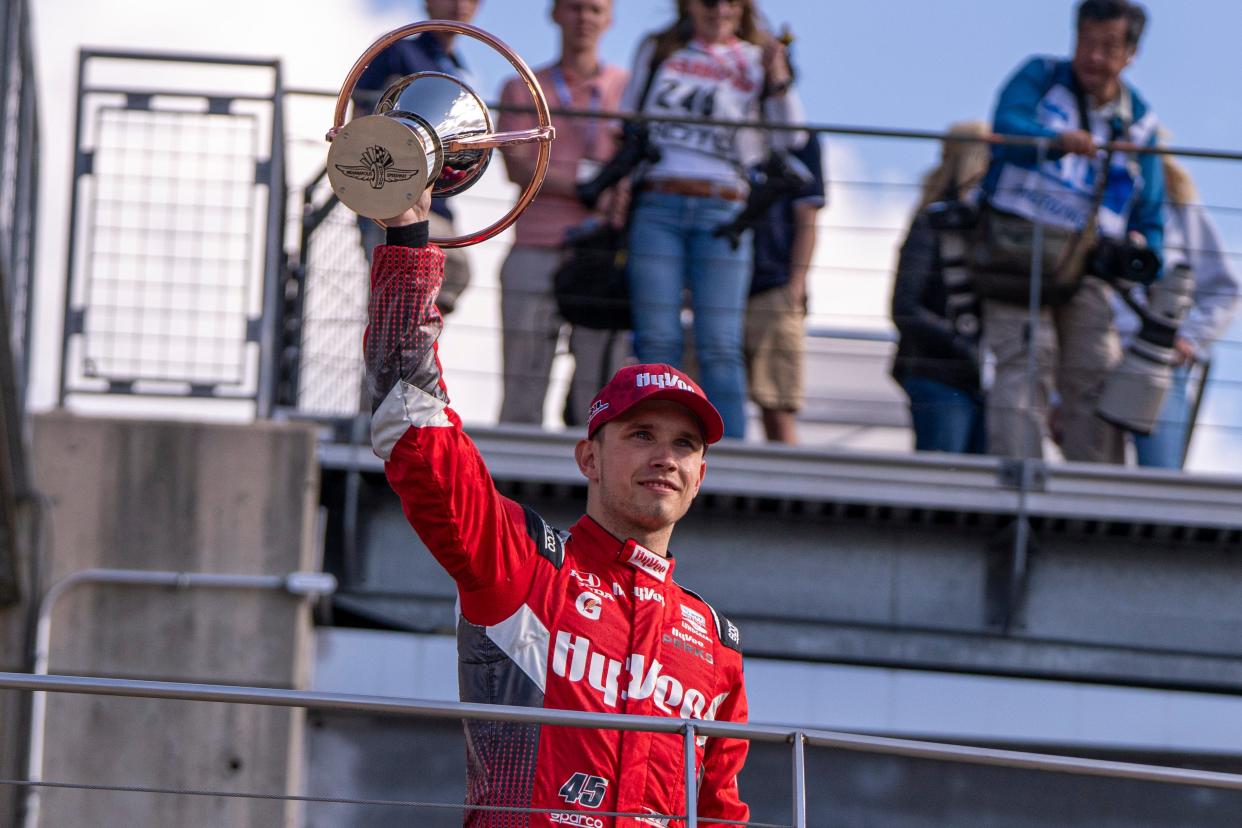 Rahal Letterman Lanigan Racing driver Christian Lundgaard (45) holds up his third place trophy, Saturday, May 11, 2024, after the Sonsio Grand Prix at Indianapolis Motor Speedway.