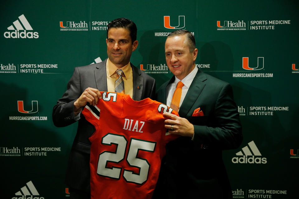 Miami coach Manny Diaz (left) poses for a photo with athletic director Blake James after their introductory news conference during happier times. (Michael Reaves/Getty Images)