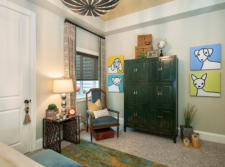 Vintage and whimsical: Bright artwork and other accessories add pops of color to this bedroom.