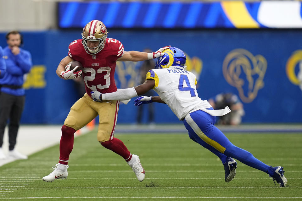 San Francisco 49ers running back Christian McCaffrey, left, fends off Los Angeles Rams safety Jordan Fuller during the first half of an NFL football game Sunday, Sept. 17, 2023, in Inglewood, Calif. (AP Photo/Gregory Bull)