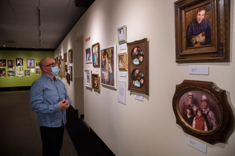 Joel Reyna looks at an Awkward Family Photos exhibition at the Haggin Museum in Stockton, California, on April 4, 2021.