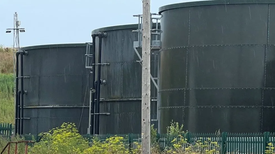 Three dark green waste tanks, belonging to the company Transwaste