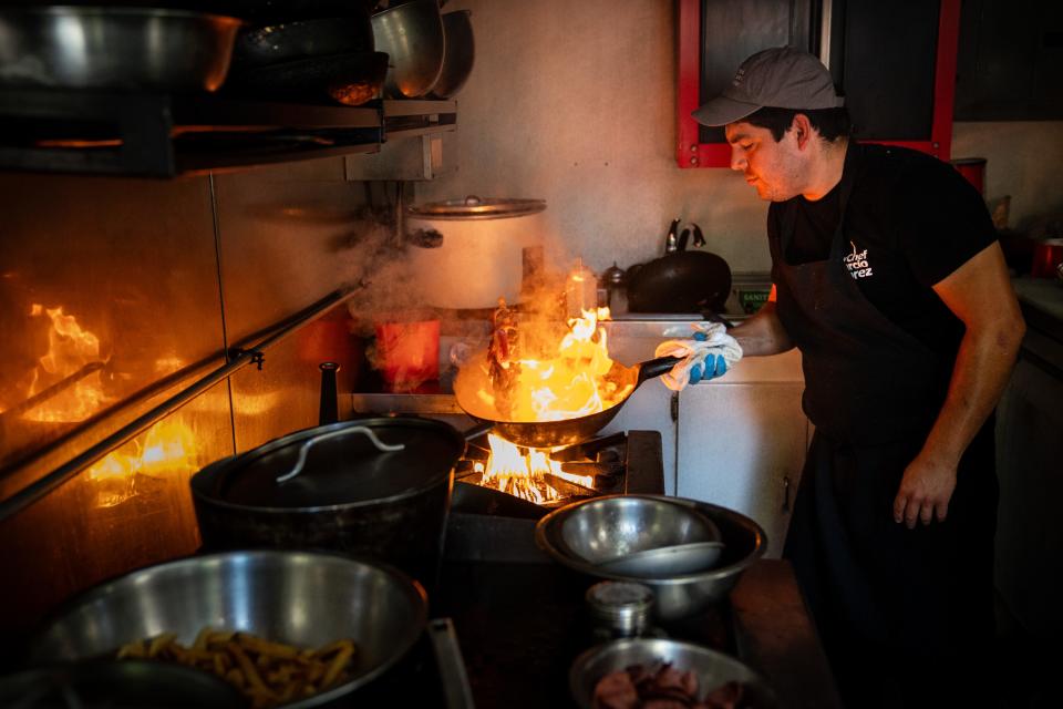 Chef Marcio Florez cooks food in The Inka Trailer during Street Eats on Deaderick Street in Nashville, Tenn., Thursday, July 6, 2023.