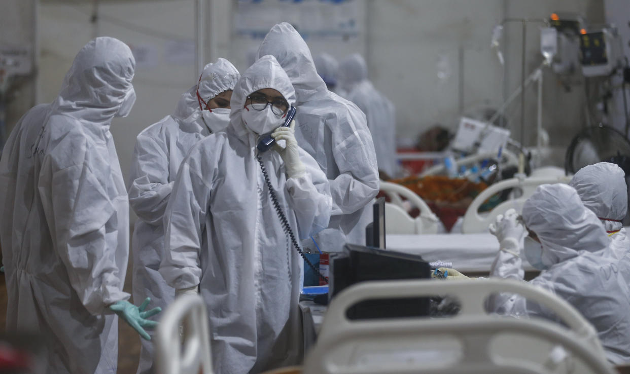 A doctor speaks on the intercom with a senior consultant giving an update of a patient at the BKC jumbo field hospital, one of the largest COVID-19 facilities in Mumbai, India, Thursday, May 6, 2021. (AP Photo/Rafiq Maqbool)