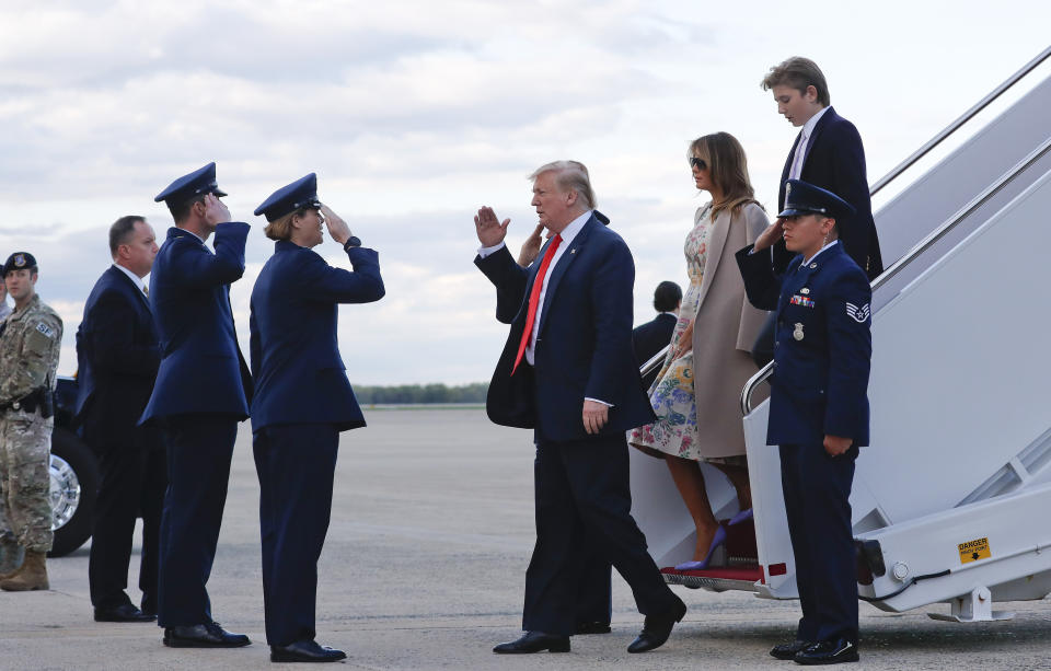 President Donald Trump, center, returns a salute during his arrival on Air Force One with first lady Melania Trump and their son Barron Trump at Andrews Air Force Base, Md., Sunday, April 21 2019. (AP Photo/Pablo Martinez Monsivais)