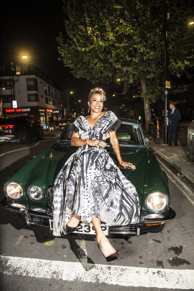 Kelly Holmes on a vintage Jaguar (Image: Attitude//Aaron Parsons)