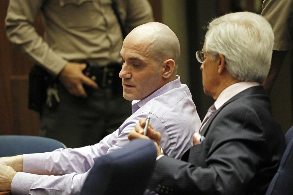 Michael Gargiulo, left, with his attorney Daniel Nardoni, listens as his guilty verdicts on all counts are read in Los Angeles Superior Court Thursday, Aug. 15, 2019. A jury found Gargiulo guilty of fatally stabbing two women and attempting to kill a third in their Southern California homes. Gargiulo, is also awaiting trial for a similar killing in Illinois in 1993. (Al Seib/Los Angeles Times via AP, Pool)