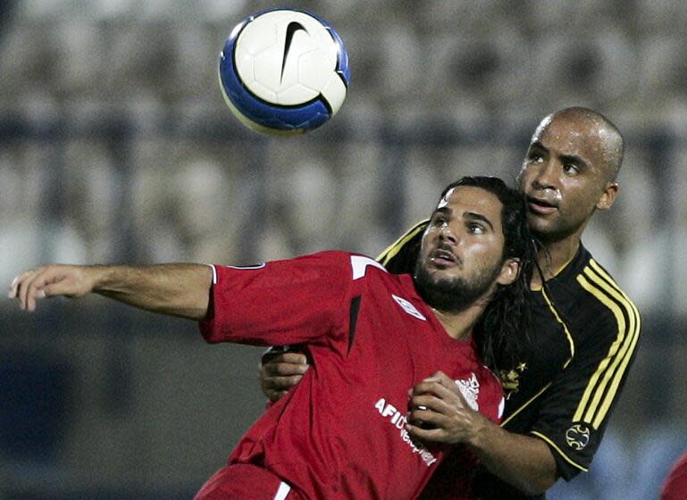 Hapoel Tel Aviv's Lior Asulin, front, vies for the ball with AIK Solna's Jimmy Tamadi during their UEFA Cup first round first leg soccer match at Bloomfield stadium in Tel Aviv, Israel, Thursday, Sep. 20, 2007. (AP Photo/Ariel Schalit)