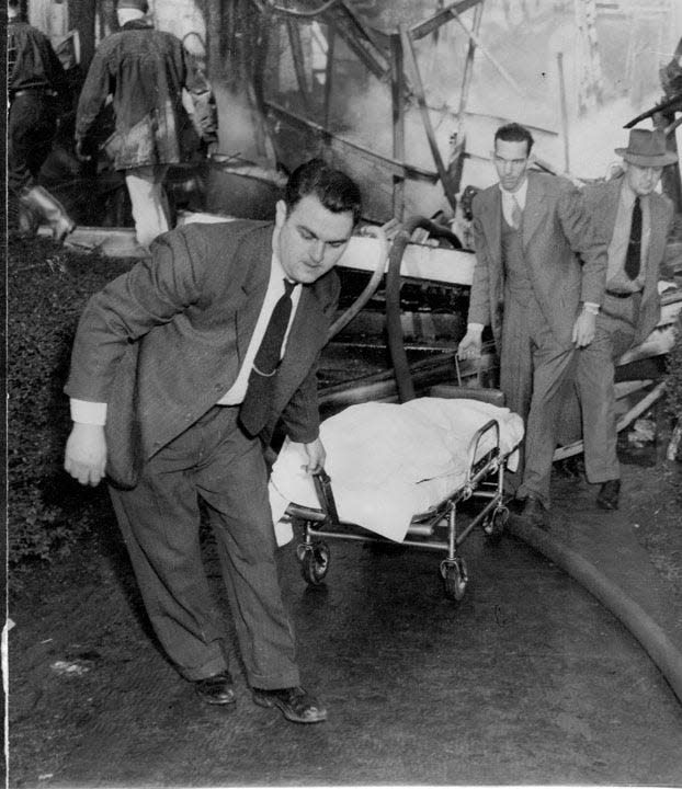 Removing a victim from the smoking remains of Central Building at Highland Hospital on March 11, 1948