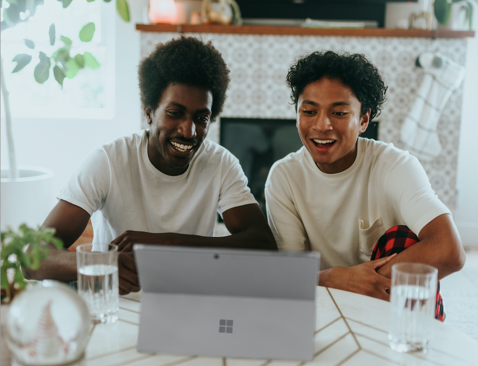 New York Slang pictured: two men laughing at computer screen | Photo via Surface/Unsplash