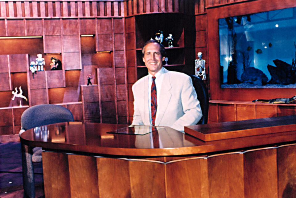 Chevy smiling at his desk