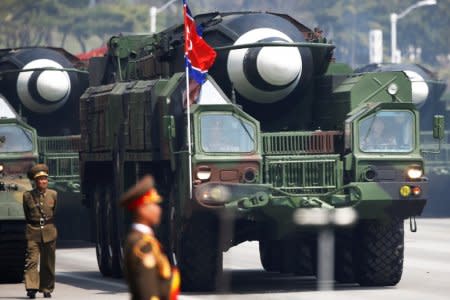 FILE PHOTO: Missiles are driven past the stand with North Korean leader Kim Jong Un and other high ranking officials during a military parade marking the 105th birth anniversary of the country's founding father, Kim Il Sung in Pyongyang, April 15, 2017.    REUTERS/Damir Sagolj/File Photo