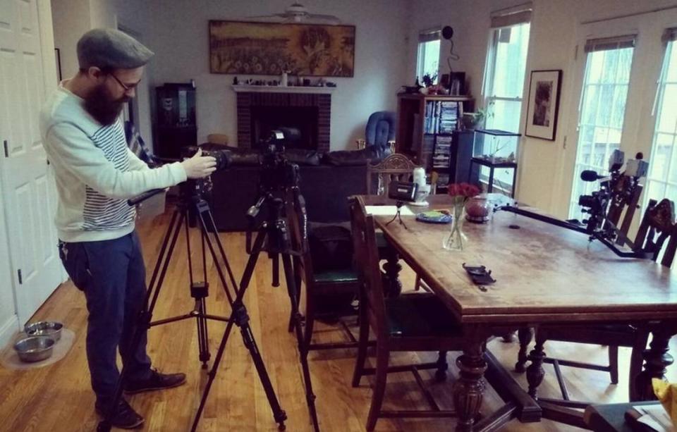 Photography adviser Hamilton Ward tests equipment before a “Familiar Shapes” interview. The podcast and film created by Heather D. Freeman compares the history of witchcraft and witch trials with contemporary social media disinformation.