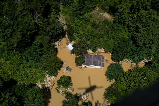 In this aerial view, floodwater surrounds a house as the Kentucky National Guard flies a recon and rescue mission in Breathitt County near Jackson, Kentucky, on July 30. (Photo: Michael Swensen/Getty Images)