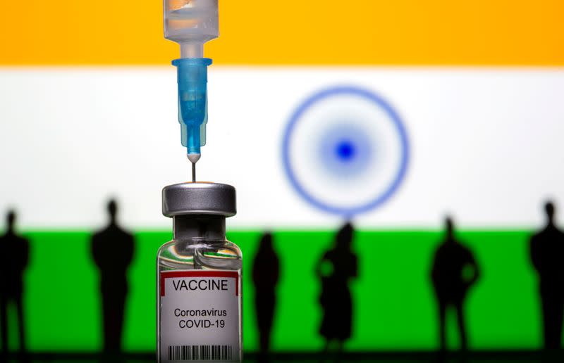 FILE PHOTO: 3D-printed small toy figurines, a syringe and vial labelled "coronavirus disease (COVID-19) vaccine" are seen in front of India flag in this illustration