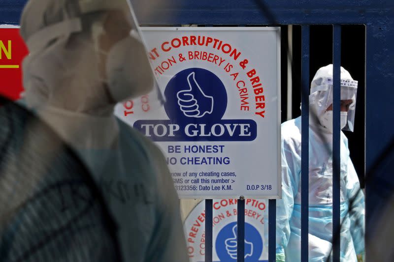 FILE PHOTO: Medical workers are seen at a Top Glove hostel under enhanced lockdown in Klang