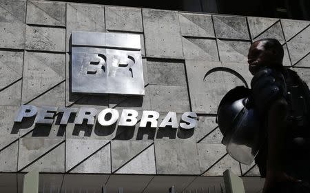 A policeman stands in front of the Petrobras headquarters during a protest in Rio de Janeiro March 4, 2015. REUTERS/Sergio Moraes