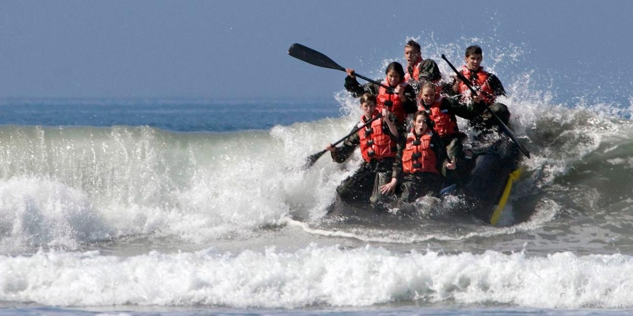 Record-breaking Olympic champion Michael Phelps (top R) and members of the U.S. National Swim Team participate in Surf Passage at Naval Special Warfare Center at Naval Amphibious Base Coronado, California, March 19, 2009. This is one of several physically demanding evolutions the team went through as they experienced a morning in the life of a Basic Underwater Demolition/SEAL student. The Basic Underwater Demolition/SEAL program is a 6-month training course where more than half the students are eliminated during a rigorous