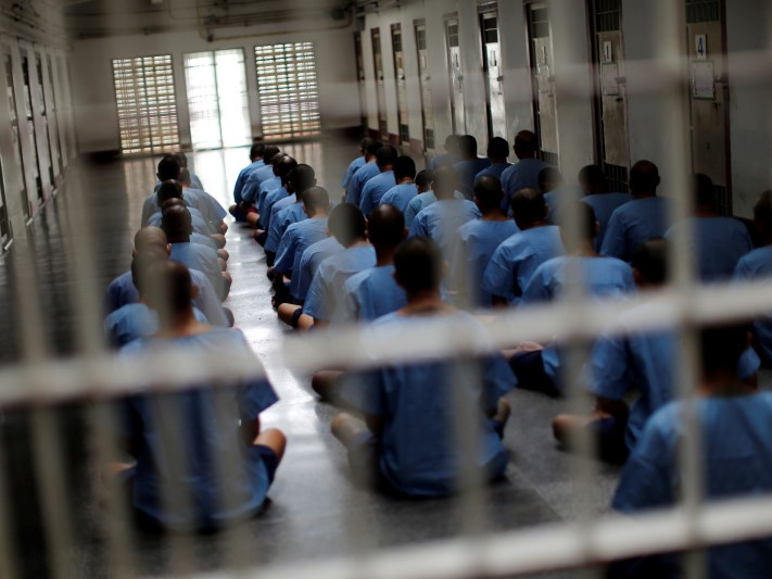 Inmates sit on the floor during an inspection visit in the long term sentence zone inside Klong Prem high-security prison in Bangkok, Thailand July 12, 2016. REUTERS/Jorge Silva