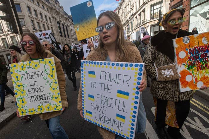 Pro-Ukraine protestors walk through the streets holding signs