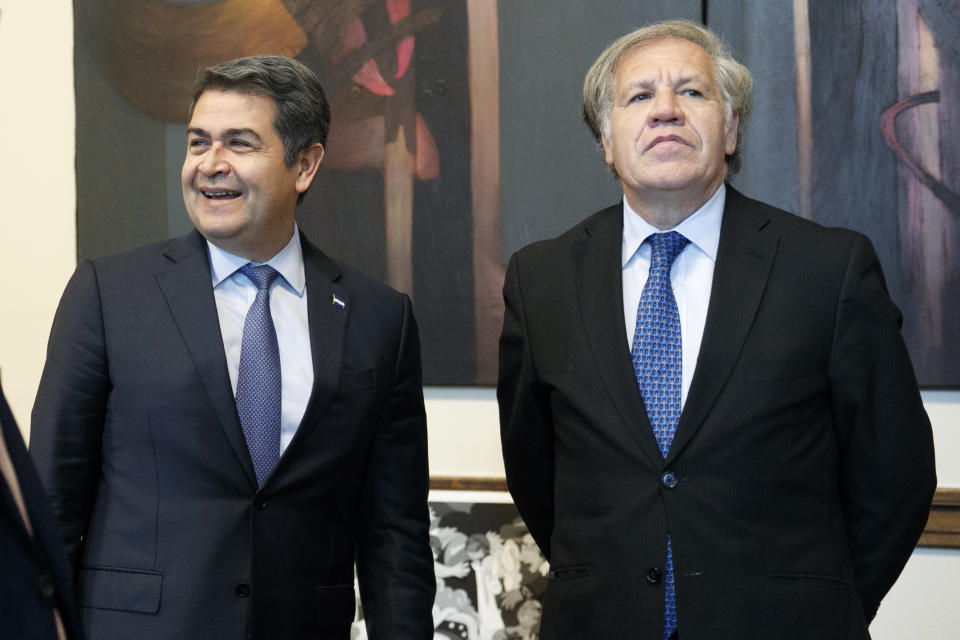 Honduran President Juan Orlando Hernandez, left, meets with Organization of American States (OAS) Secretary General Luis Almagro, Tuesday, Aug. 13, 2019, at the Organization of American States, in Washington. (AP Photo/Jacquelyn Martin)