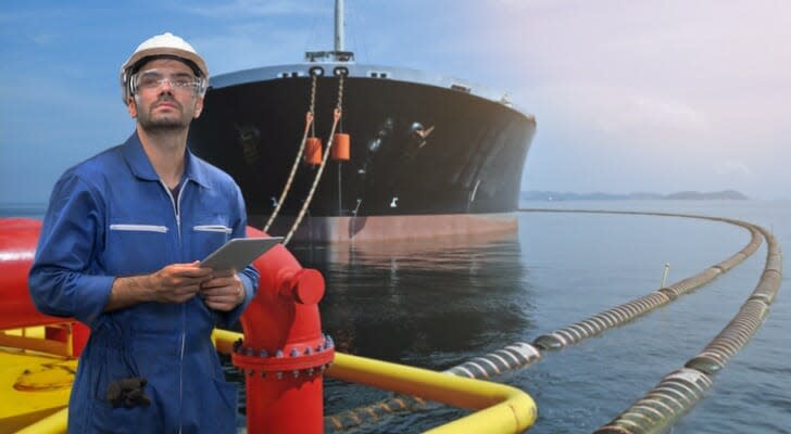 Oil tanker with man in front of it