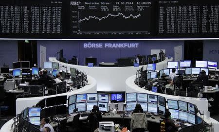 Traders are pictured at their desks in front of the DAX board at the Frankfurt stock exchange August 13, 2014. REUTERS/Remote/Stringer