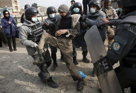 Police detain a man to be taken to a newly-opened treatment centre at Camp Phoenix, during a round up of suspected drug addicts in Kabul, Afghanistan December 27, 2015. REUTERS/Ahmad Masood