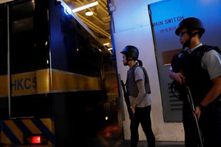 Armed policemen stand guard at the entrance as a prison car carrying British former banker Rurik Jutting enters High Court to launch his appeal, in Hong Kong, China December 13, 2017. REUTERS/Tyrone Siu