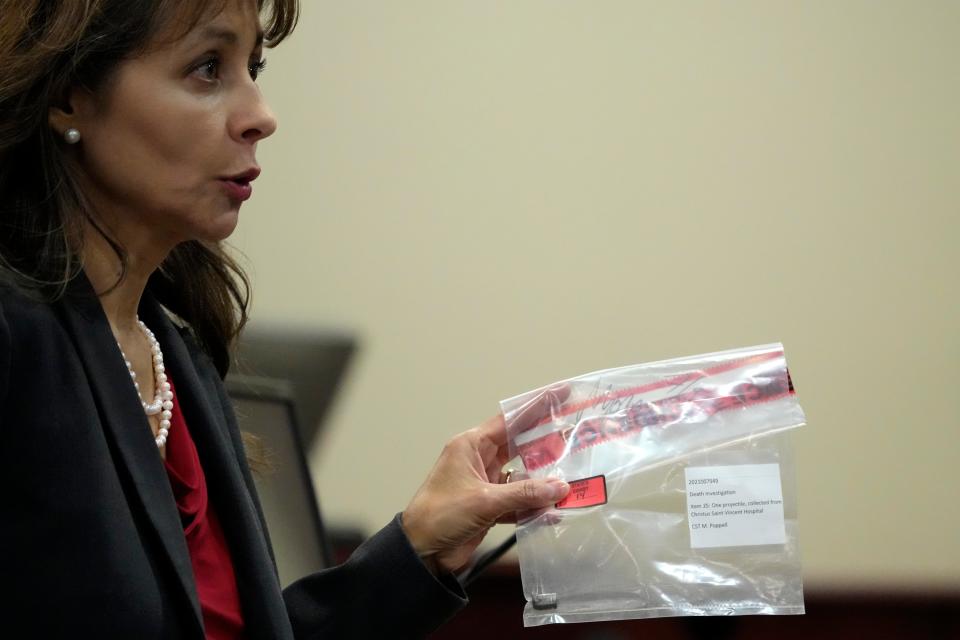 Special prosecutor Erlinda Ocampo Johnson shows a bullet in an evidence bag during the trial (AP)