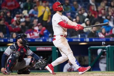 Mar 31, 2019; Philadelphia, PA, USA; Philadelphia Phillies right fielder Bryce Harper (3) hits a home run in front of Atlanta Braves catcher Brian McCann (16) during the seventh inning at Citizens Bank Park. Mandatory Credit: Bill Streicher-USA TODAY Sports