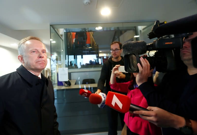 Latvia's central bank governor Ilmars Rimsevics, accused of accepting bribes, stands before members of the media as he arrives for a court hearing in Jurmala