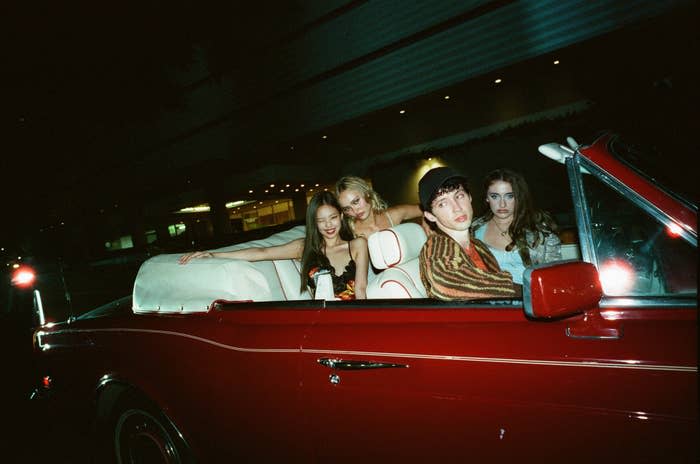 The cast of "The Idol" sitting in a convertible