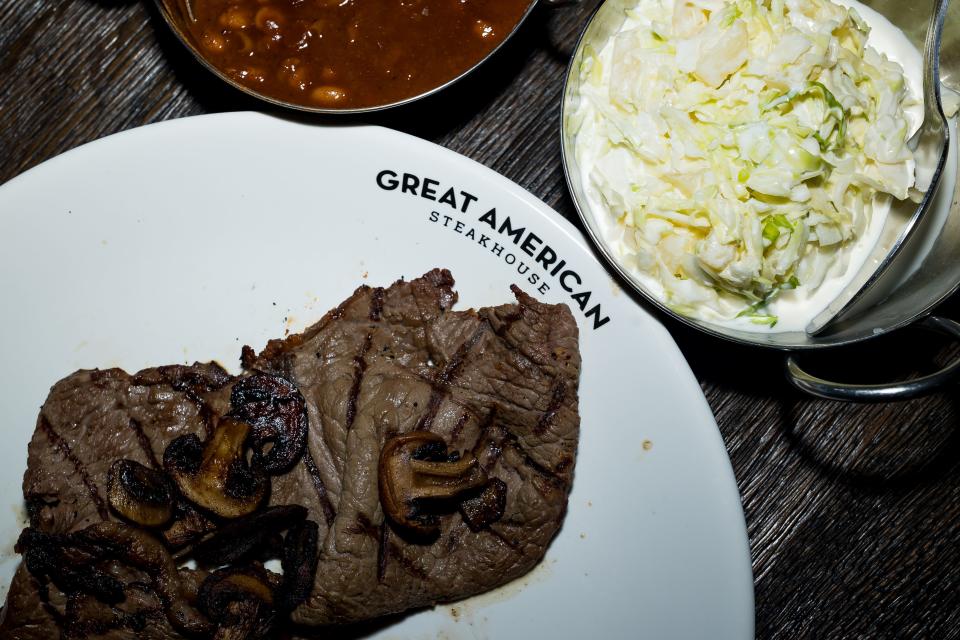 A sirloin steak with coleslaw and beans is prepared at the newly remodeled Great American Steakhouse in Northeast El Paso on Tuesday, Jan. 9, 2024. The restaurant recently reopened right before the new year.