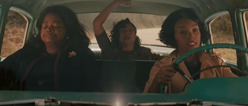 Octavia Spencer, Taraji P. Henson, and Janelle Monáe are in a car. Taraji Henson is in the backseat, with Octavia Spencer driving and Janelle Monáe in the front passenger seat