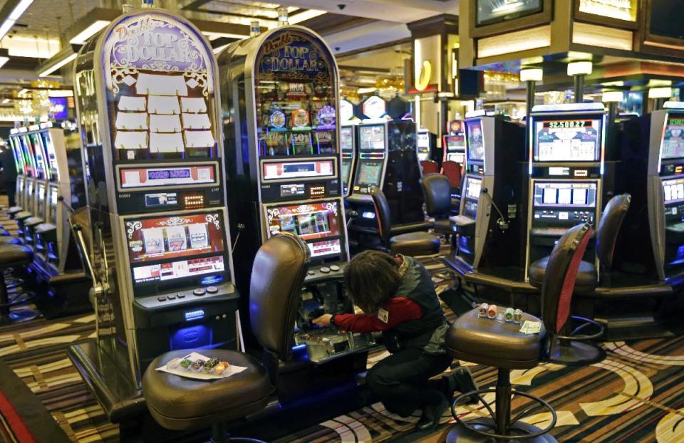 A worker checks a slot machine inside Horseshoe Casino Cincinnati, Tuesday, Feb. 26, 2013, in Cincinnati. Denominations among more than 2,000 slots and video poker machines range from $.01 to $500 per spin at the casino is set to open to the public Monday, March 4. (AP Photo/Al Behrman)