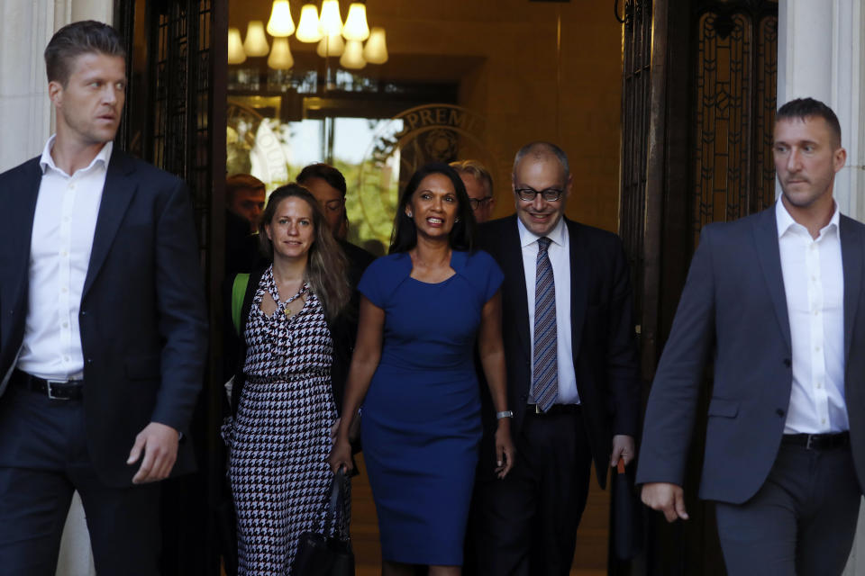 Anti-Brexit campaigner Gina Miller, centre, leaves The Supreme Court flanked by security, in London, Tuesday, Sept. 17, 2019. The Supreme Court is set to decide whether Prime Minister Boris Johnson broke the law when he suspended Parliament on Sept. 9, sending lawmakers home until Oct. 14 — just over two weeks before the U.K. is due to leave the European Union.(AP Photo/Alastair Grant)