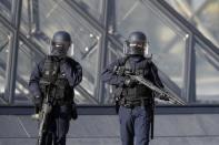 French police secure the site near the Louvre Pyramid in Paris, France, February 3, 2017 after a French soldier shot and wounded a man armed with a knife after he tried to enter the Louvre museum in central Paris carrying a suitcase, police sources said. REUTERS/Christian Hartmann